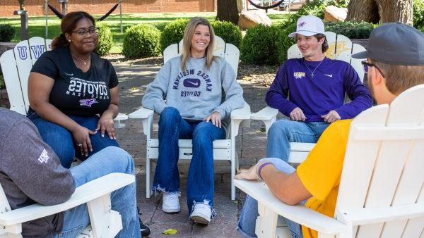 Students sitting in chairs outside